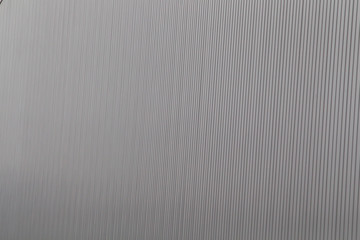 Wide shot of silver corrugated metal with bolts