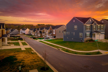 Fototapeta na wymiar American single family home street with stunning red, orange sunset view