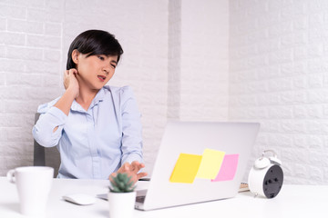 Woman scratching her skin at office
