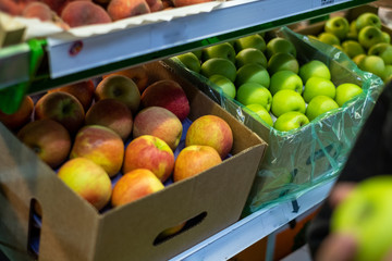 red and green apples in the store in boxes
