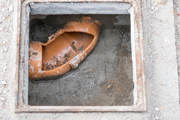 in the ground there is a plastic tube for shit