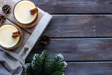 Eggnog - cute New Year composition with alcoholic drink on dark wooden background top view frame copy space