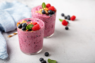 Berry smoothies with raspberries and blueberries with copy space