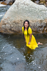 beautiful woman with yellow dress inside the water