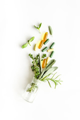 Herbal formulations for health care - herbs and drugs on white background top view copy space