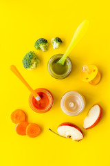 Vegetable and fruits puree for feed babies on yellow background top view