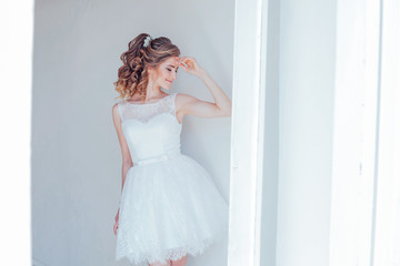 pretty girl in a short white wedding dress