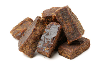 brown cubes of sugar on white background
