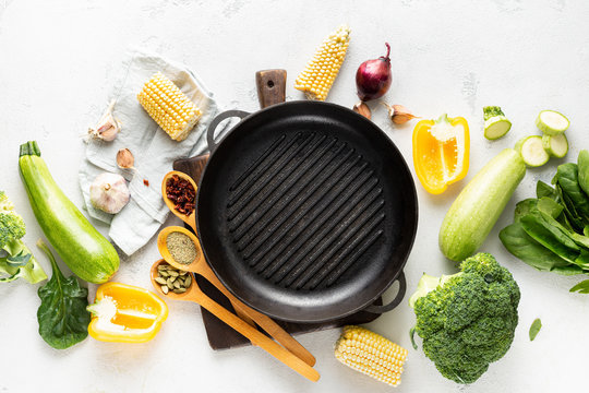 World vegan day concept. Empty grill pan with fresh vegetarian various ingredients for cooking vegan grilled food top view - Powered by Adobe