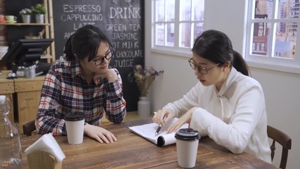 Young female candidate and hr manager laughing at job interview in cafe. colloquy dream job concept. human resource woman explaining firm competitive salary and also offer attractive employee benefit