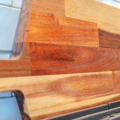 Square frame Close up of wooden chopping board behind stove