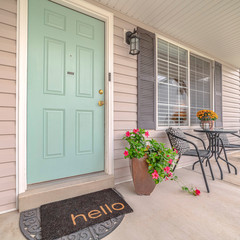 Square Front door of suburban home with welcome mat