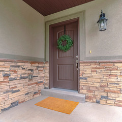 Square frame Entrance door to a house with feature stone wall