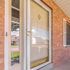 Square frame Front door of suburban brick home with welcome mat