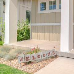 Square frame Front veranda of modern home with welcome sign