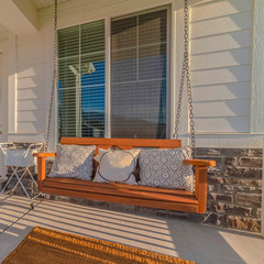 Square frame Front veranda of modern home with swinging chair