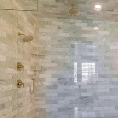 Square Interior of stone tiled contemporary bathroom teal tile