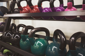Obraz na płótnie Canvas multi-colored kettlebells in the gym, the concept of sports and physical activity