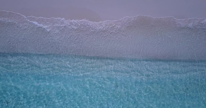 Beautiful Footage Of Waves Breaking Gently Onto The Shore In Canada - Aerial Shot