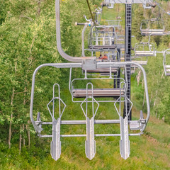 Naklejka premium Square frame Close up of chairlifts with view of hiking trails on a mountain in Park City