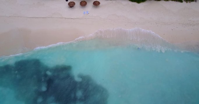 Maldives Island Aqua Blue Sea Waters, Waves Kissing The White Sand Under The Heat of The Sun - Aerial Shot
