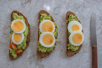 sliced avocado and egg on toasted bread for healthy breakfast
