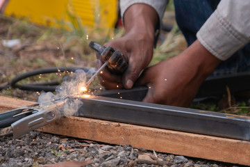 Industrial worker with heavy tool in machinery shop