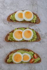 sliced avocado and egg on toasted bread for healthy breakfast