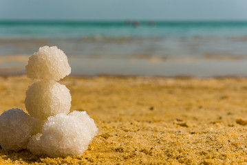 Relax balls of salt on the sand. Sky horizon. Sea. Sand.