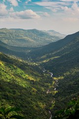 Naklejka premium Water flowing into Venna Valley from Lingmala Waterfall on a cloudy afternoon, in Mahabaleshwar, Maharashtra, India 