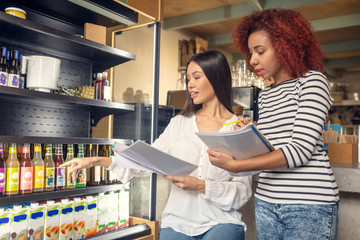 Young business partners owning cafeteria ordering drinks