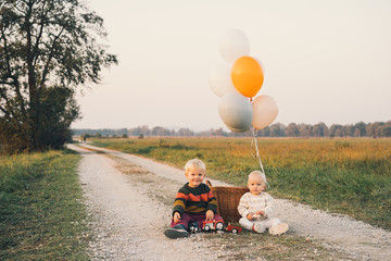 Little children playing on nature. Family outdoors