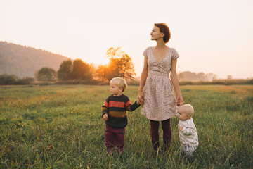 Family on nature. Mother with children outdoors.