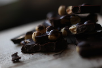 broken pieces of black chocolate with nuts