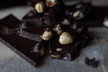 broken pieces of black chocolate with nuts