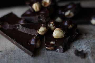 broken pieces of black chocolate with nuts