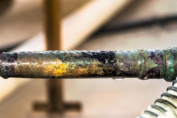humid leaking pipe of a central air conditioning system and cold water drops on it