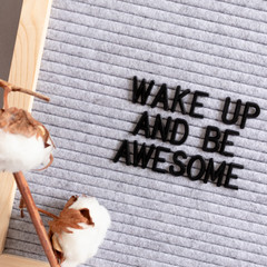 Cotton branches and letterboard with quote Wake up and be awesome