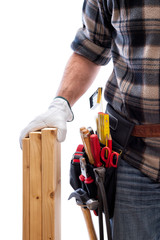 Carpenter isolated on a white background; he wears leather work gloves, he is holding wooden boards. Work tools industry construction and do it yourself housework. Stock photography.