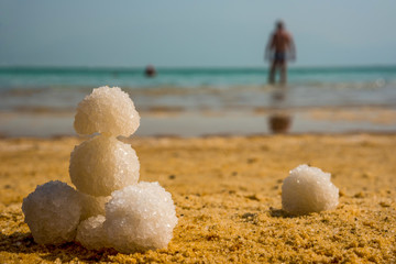 Fototapeta na wymiar Relax balls of salt on the sand. Sky horizon. Sea. Sand.