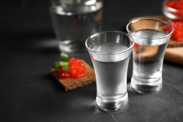 Cold Russian vodka on black table, closeup view