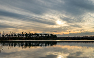 Fototapeta na wymiar Evening landscape. Clouds over the lake.