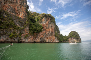 green sea and big mountains. Small boat and yacht in the sea. beautiful natural landscape. Andaman Sea, Krabi Thailand