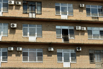 Brick wall of Office building with windows and air conditioning
