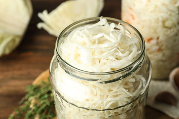 Jar of tasty fermented cabbage on table, closeup