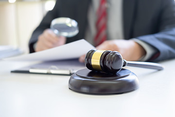 Judge gavel with Justice lawyers having team meeting at law firm background. Concepts of Law and...