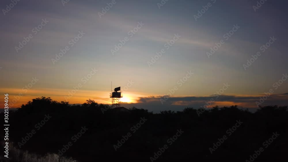 Poster a silhouette of radar tower at the airport rotating steadily for the detection of aircraft by using 