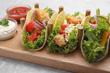 Delicious fish tacos served on grey marble table