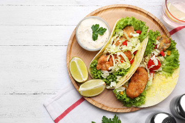 Delicious fish tacos served on white wooden table, flat lay