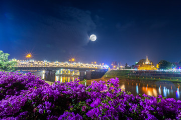 Beautiful scene light color The Loy Krathong festival at Pagoda in the Temple That riverside the Nan River at night is a tourist attraction Phitsanulok, Thailand. With full moon